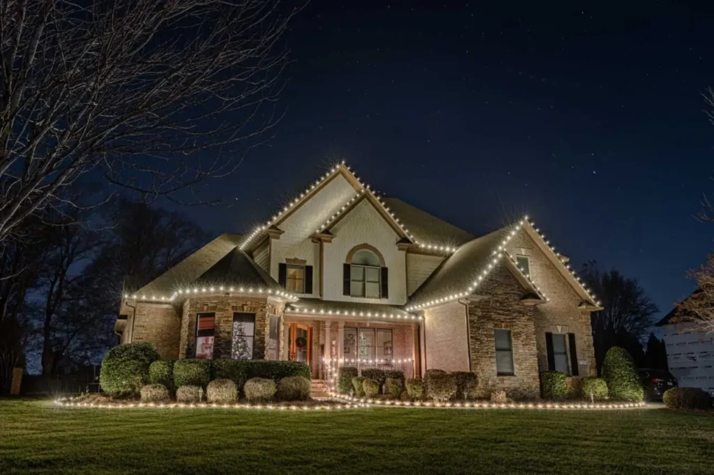 Warm white Christmas lights outlining an Atlanta-area home and front porch.