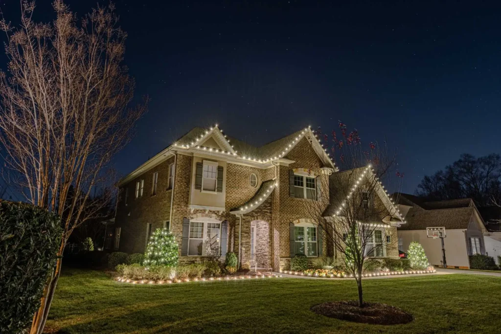Warm white Christmas light installation outlining a two-story Atlanta home