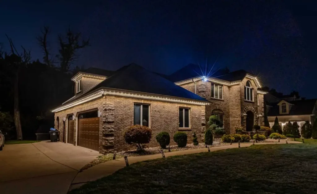 Warm white roofline Christmas lights with blue accent lighting on an Atlanta-area home.
