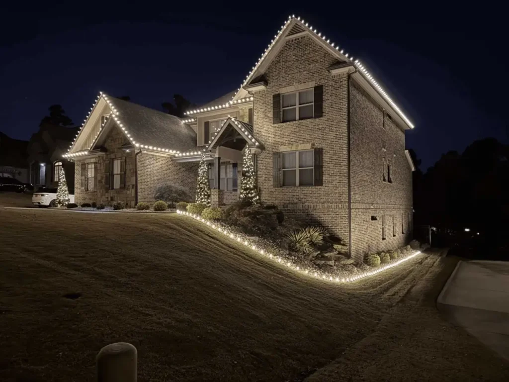 Warm white Christmas lights outlining a home roofline and front walkway in Atlanta.