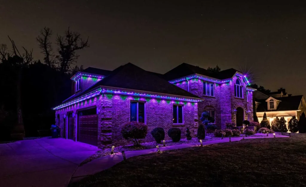Atlanta home illuminated with purple and multicolor permanent Christmas lights