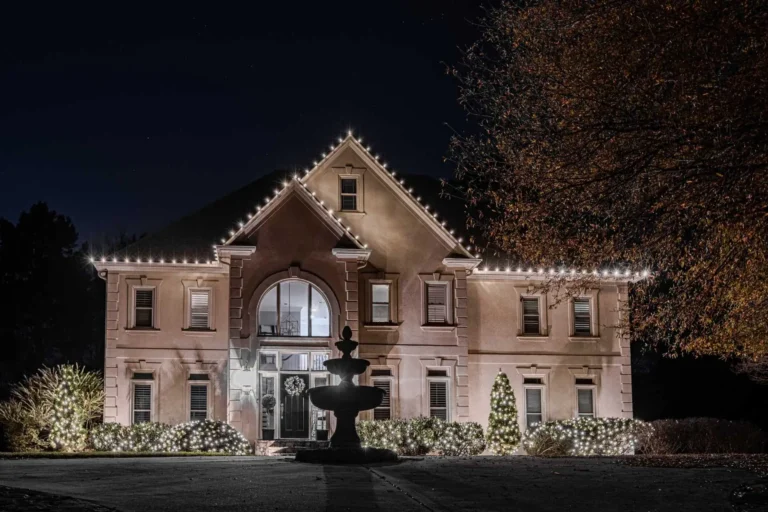 Warm white residential Christmas lights highlighting a large Atlanta-area home.