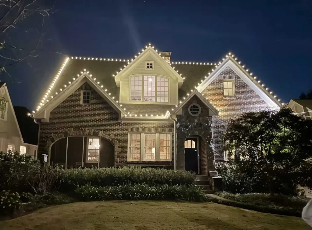 Warm white Christmas lights tracing the roofline of an Atlanta-area home.