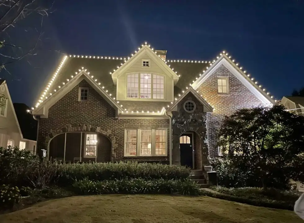 Warm white Christmas lights tracing the roofline of an Atlanta-area home.